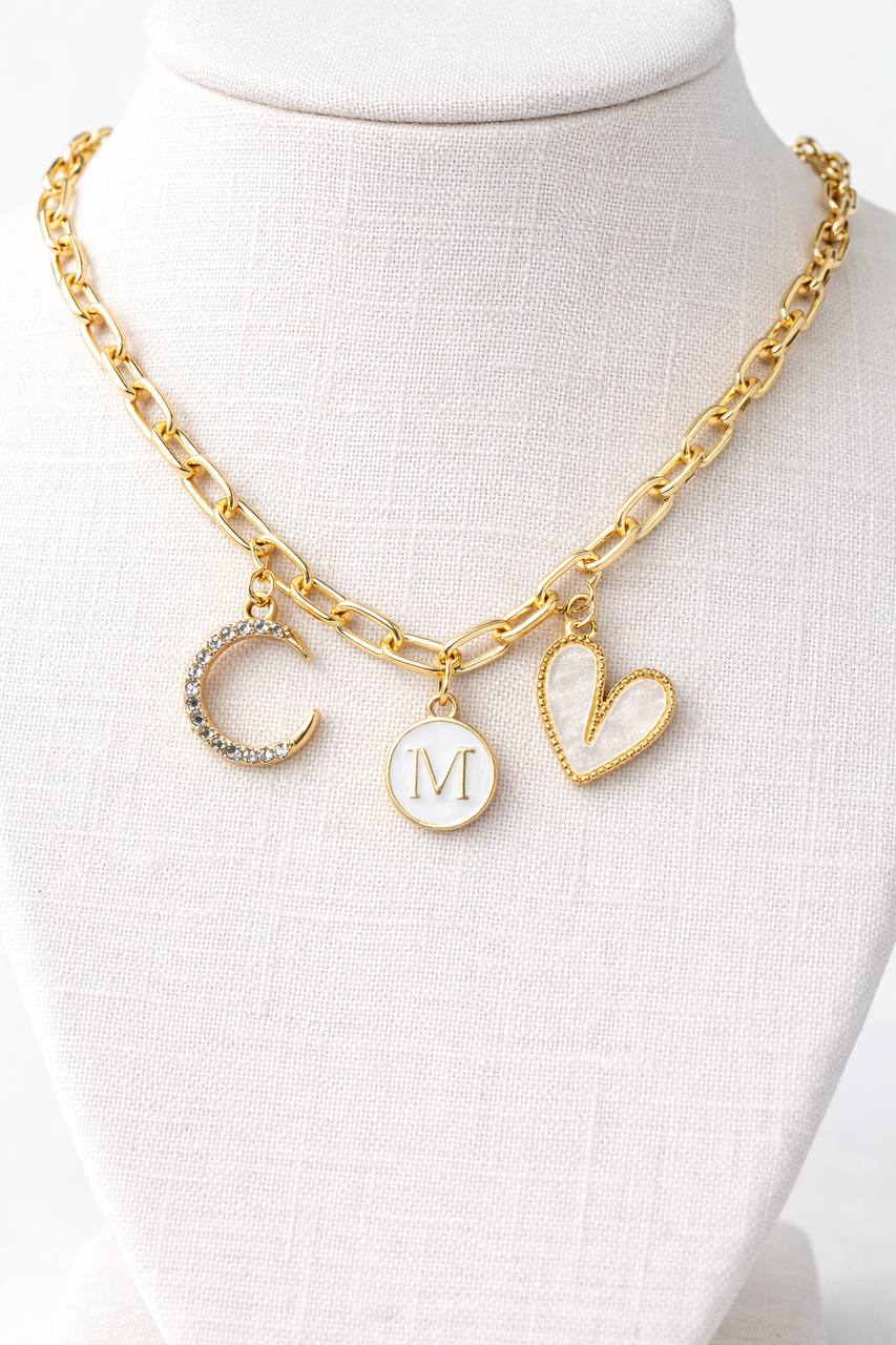 Gold necklace with charms on a mannequin bust