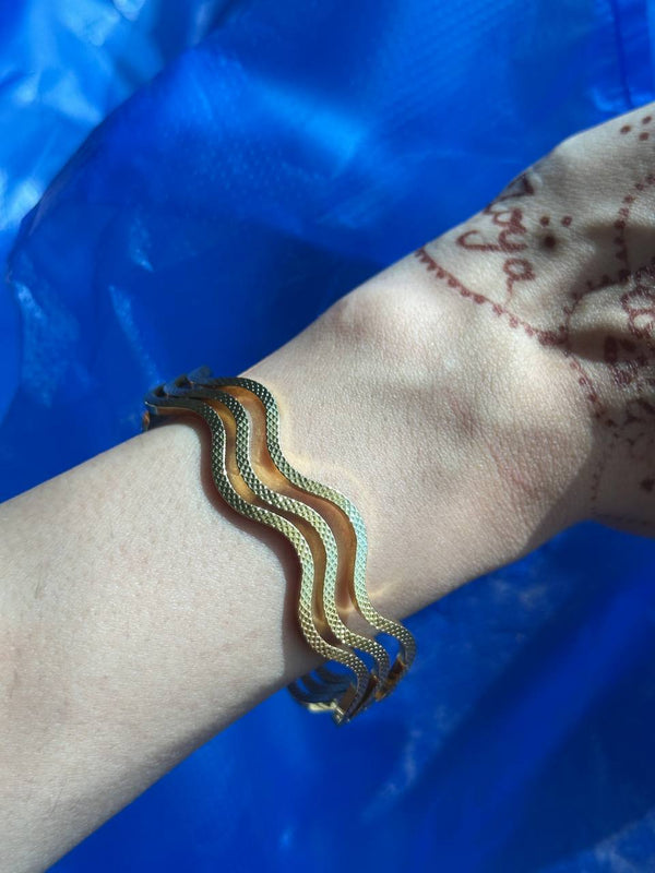 Bracelet on a wrist with a blue background