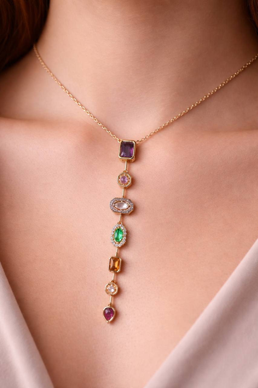 Gold necklace with colorful gemstones on a person's neck