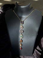 Necklace with colorful gemstones on a black mannequin bust