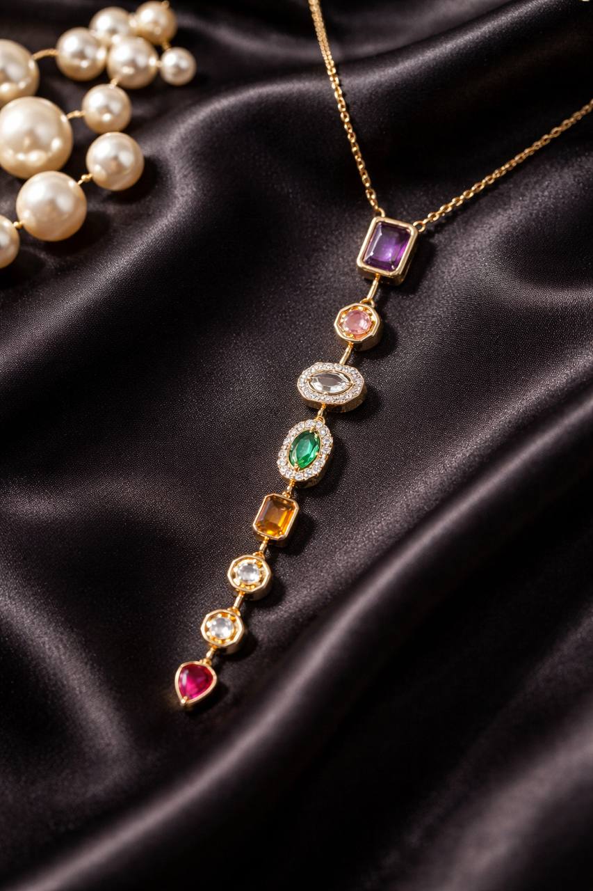 Gold necklace with colorful gemstones on a dark fabric background