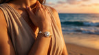 Woman wearing a bracelet on a beach with sunset in the background