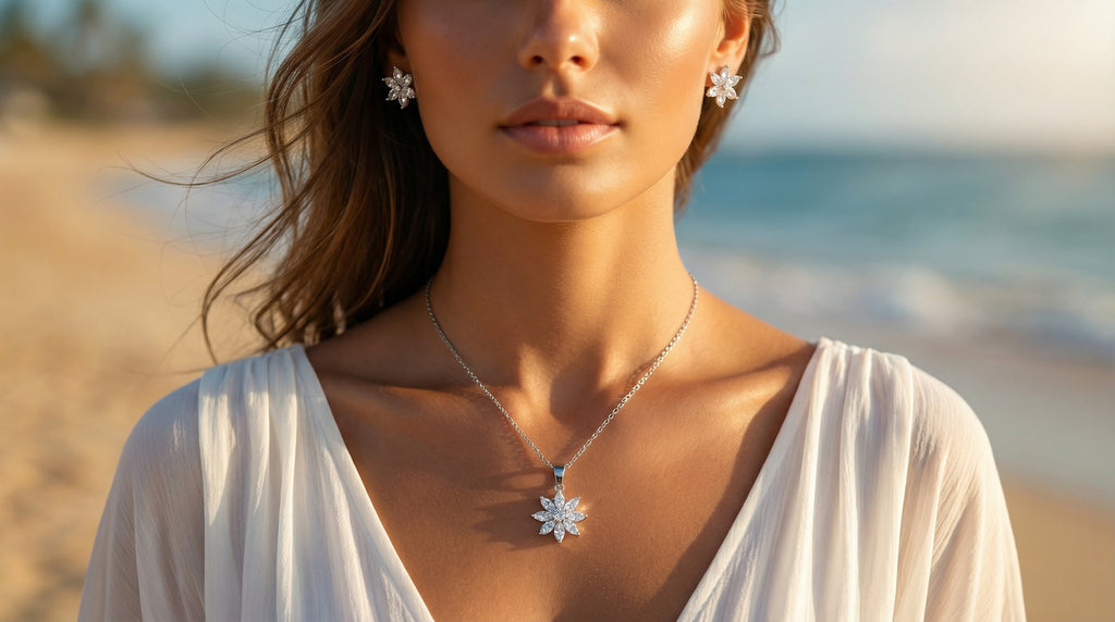 Woman wearing a necklace and earrings with a blurred beach background