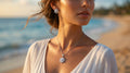 Woman wearing a necklace with a pendant on a beach