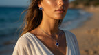 Woman wearing a necklace with a blue pendant on a beach