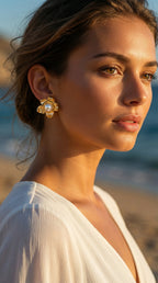 Woman wearing gold earrings on a beach