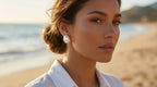 Woman wearing pearl earrings on a beach