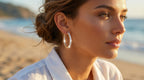 Woman wearing hoop earrings on a beach