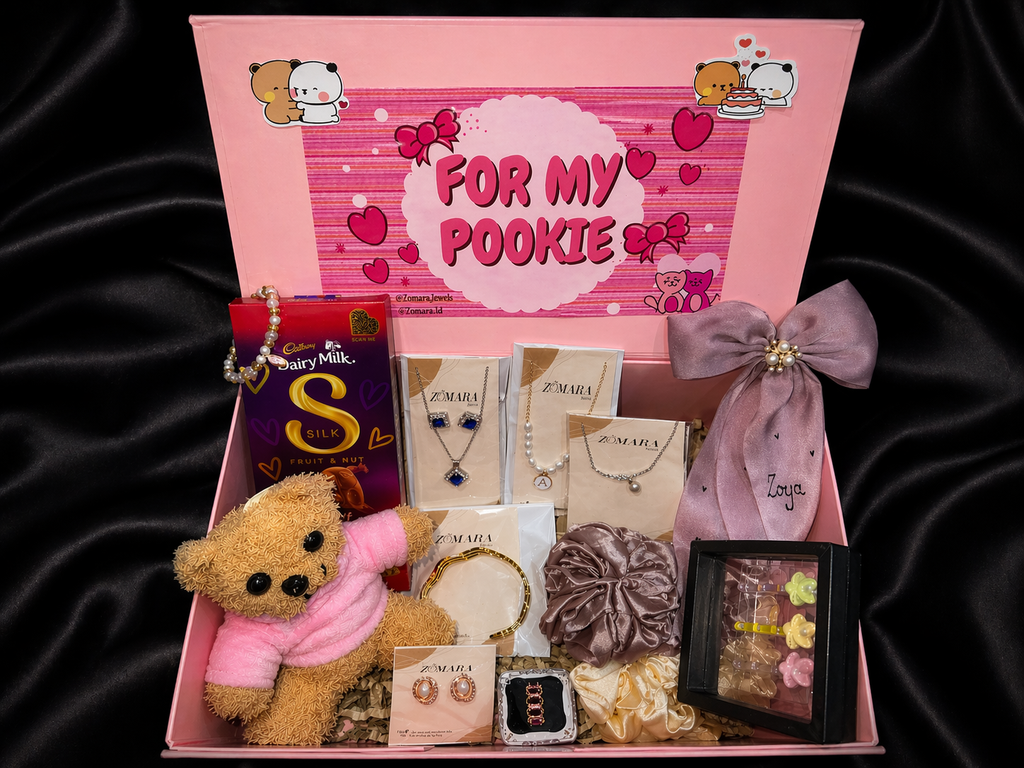 Luxury gift hamper for girlfriend featuring a teddy bear, jewelry, chocolates, and decorative items.