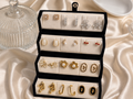 12-pair vintage floral and pearl gold-tone earring set displayed in an elegant gift box