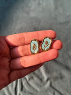 Pink floral stud earrings with gold tone border