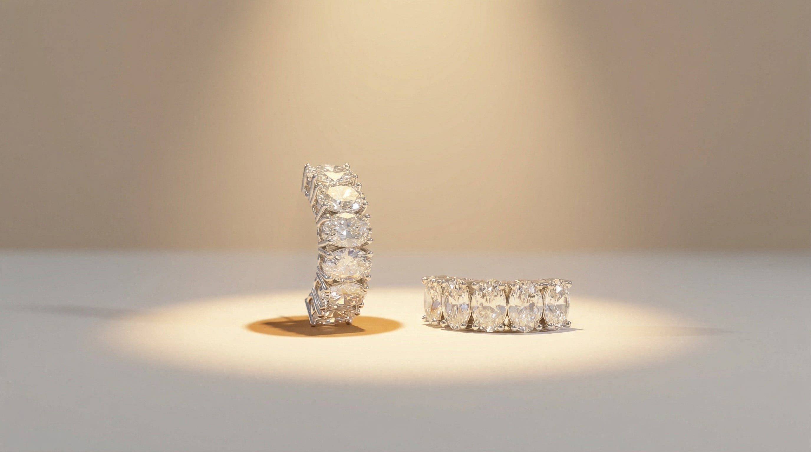 Two diamond rings on a light surface with a neutral background
