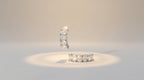 Two diamond rings on a light gray background
