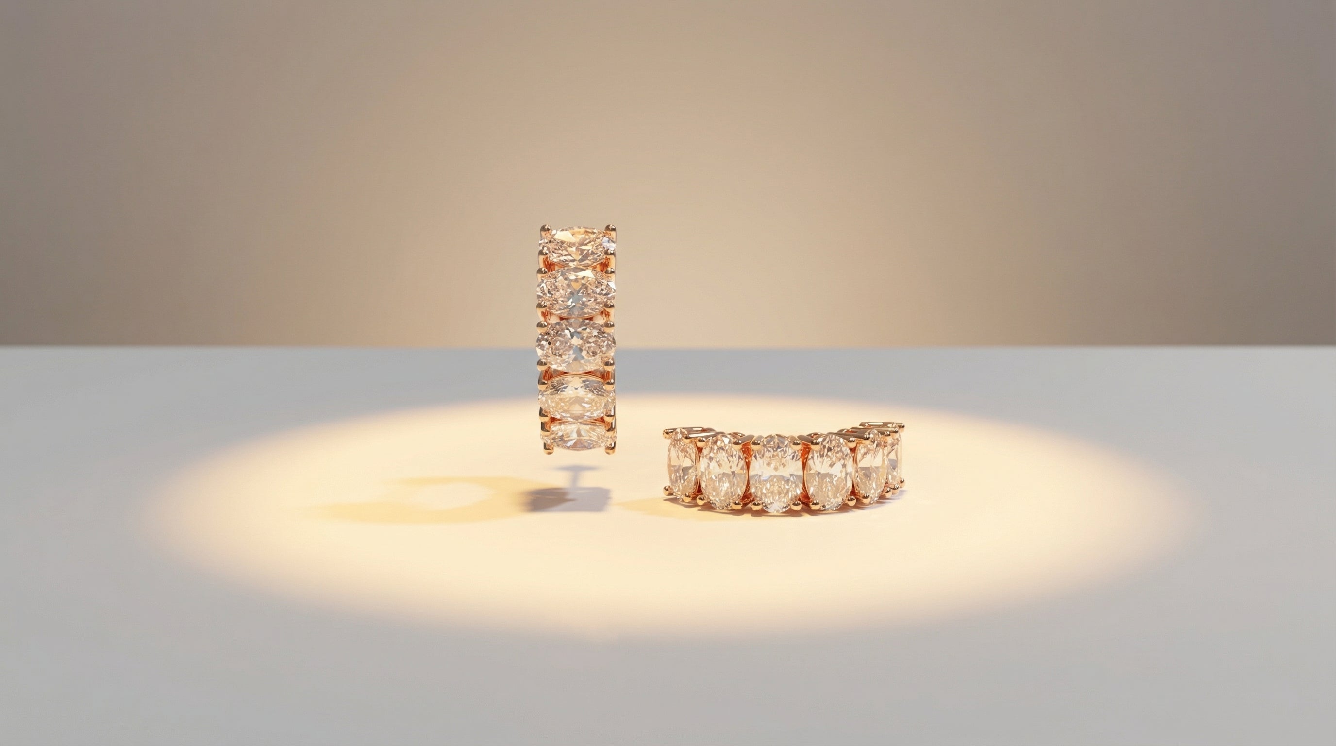 Two diamond rings on a light surface with a neutral background