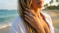 Woman on a beach wearing a ring with a purple gemstone