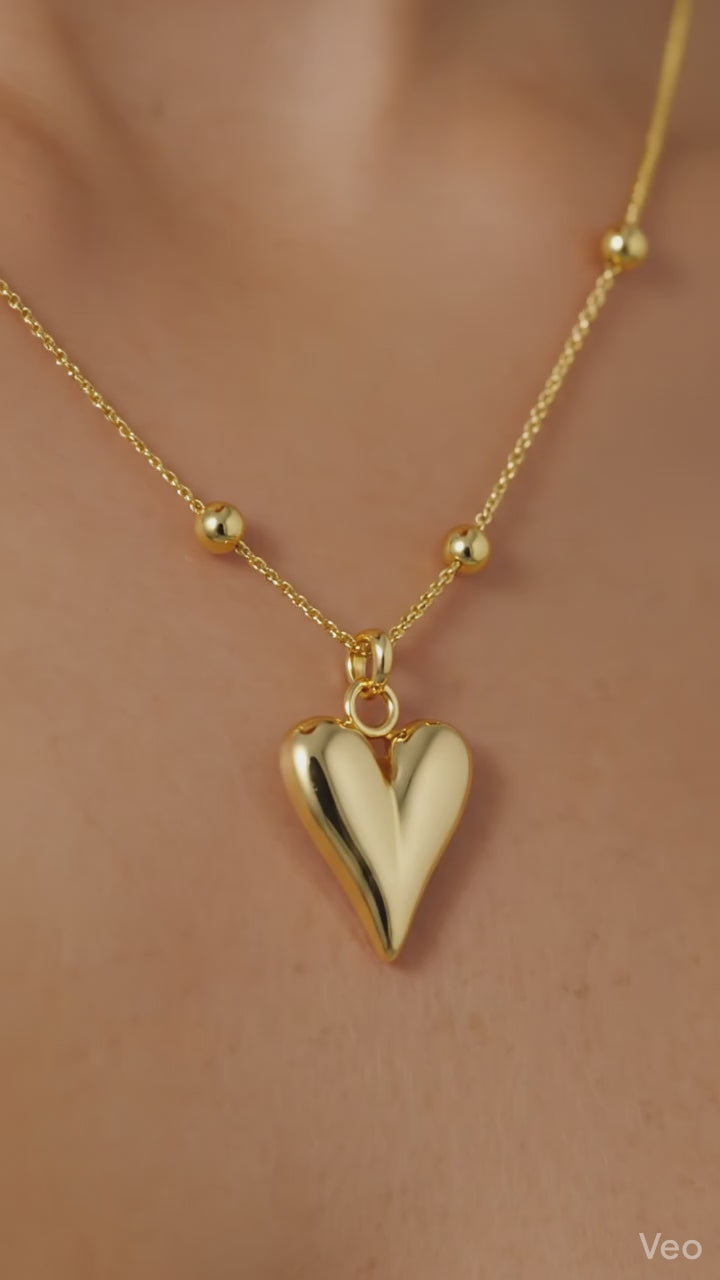 Luxe Gold Heart Pendant Necklace – Premium Elegant Chain showcasing a polished gold heart charm on a delicate beaded chain.