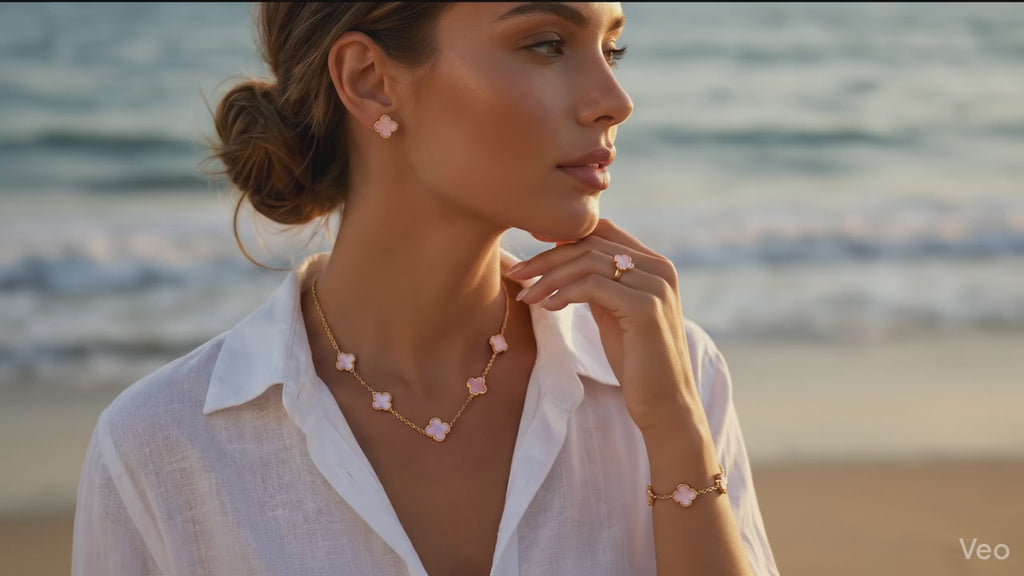 Woman on a beach wearing pink jewelry with a blurred background